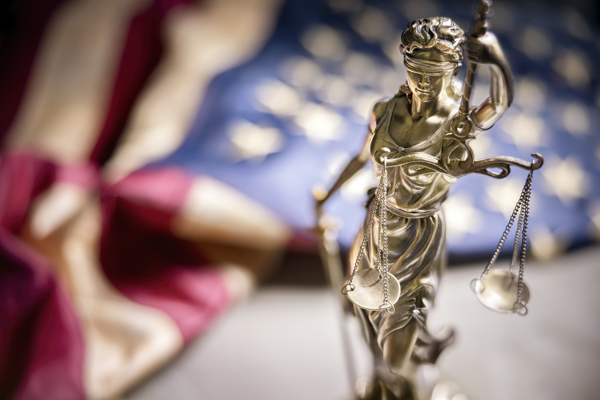 American legal system law concept statue of lady justice with scales of justice and american flag background